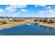 Beautiful aerial view of homes surrounding a scenic pond on a bright, sunny day with a water tower in the background at 14347 Camelot House Way, Fishers, IN 46037