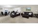Finished basement with a dining area, theater seating and a variety of leather couches at 14347 Camelot House Way, Fishers, IN 46037