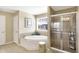 A bathroom featuring a shower, soaker tub, window, and neutral paint at 14347 Camelot House Way, Fishers, IN 46037