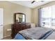 Comfortable bedroom with a dresser, a mirror, and a window offering natural light at 14347 Camelot House Way, Fishers, IN 46037