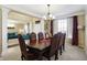 Formal dining room features a grand chandelier and elegant furnishings, perfect for gatherings at 14347 Camelot House Way, Fishers, IN 46037