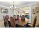 Elegant dining room with ample seating, chandelier, and views of the living area at 14347 Camelot House Way, Fishers, IN 46037