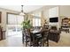 Bright dining area with large windows, a wooden table, and views of the backyard at 14347 Camelot House Way, Fishers, IN 46037
