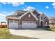 Charming two-story home with brick and stone accents and a spacious three-car garage at 14347 Camelot House Way, Fishers, IN 46037