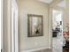 Warm neutral hallway features a tiled floor, elegant mirror, and a decorative floral arrangement at 14347 Camelot House Way, Fishers, IN 46037
