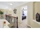 Hallway with view into a bedroom with a ceiling fan and carpet at 14347 Camelot House Way, Fishers, IN 46037