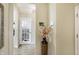 Inviting hallway with neutral paint, tiled floor and decorative vase with floral arrangement at 14347 Camelot House Way, Fishers, IN 46037