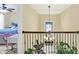 Hallway with railing overlooking chandelier and bedroom view in the background at 14347 Camelot House Way, Fishers, IN 46037