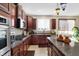 Well-equipped kitchen with stainless steel appliances, granite countertops, and stylish lighting at 14347 Camelot House Way, Fishers, IN 46037