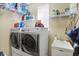 Efficient laundry room with modern washer and dryer, sink and functional storage shelving at 14347 Camelot House Way, Fishers, IN 46037