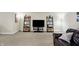 Entertainment area showcasing ladder shelves, a TV, and comfortable leather seating at 14347 Camelot House Way, Fishers, IN 46037