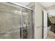 Walk in shower featuring gray tile, glass door and shower rack at 14347 Camelot House Way, Fishers, IN 46037