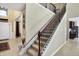 Grand staircase with dark wood and iron railings, leading to the upper level at 14347 Camelot House Way, Fishers, IN 46037
