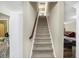 Staircase with carpet runner and a dark wood banister at 14347 Camelot House Way, Fishers, IN 46037
