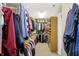 Walk-in closet with rows of hanging clothing and shelves for organization at 14347 Camelot House Way, Fishers, IN 46037