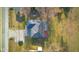 Aerial view showcases the home's location, mature trees, and proximity to neighborhood amenities at 15620 E State Road 46, Columbus, IN 47203
