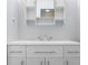 Bright bathroom featuring a white vanity with storage and a mirror with built-in shelving at 15620 E State Road 46, Columbus, IN 47203