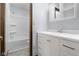 Bright bathroom featuring a white vanity with storage, a mirror with built-in shelving, and a bathtub at 15620 E State Road 46, Columbus, IN 47203