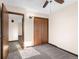 Cozy bedroom featuring a ceiling fan, closet, carpeted floor, and warm-toned decor at 15620 E State Road 46, Columbus, IN 47203