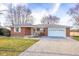 Charming brick ranch-style home featuring a well-maintained yard and a spacious gravel driveway at 15620 E State Road 46, Columbus, IN 47203