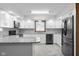 Modern kitchen featuring white cabinets, stainless steel appliances, and granite countertops at 15620 E State Road 46, Columbus, IN 47203