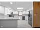Renovated kitchen with stainless steel appliances, granite countertops, and subway tile backsplash at 15620 E State Road 46, Columbus, IN 47203