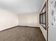 Bright living room with wood-look flooring and a large bay window providing natural light at 15620 E State Road 46, Columbus, IN 47203