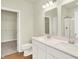 Bathroom featuring a double sink vanity, toilet, and walk in closet with shelving in the background at 1603 Clover Crossing Dr # 1A, Greenfield, IN 46140