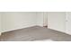 A carpeted bedroom with neutral walls, a door and large baseboard trim at 1603 Clover Crossing Dr # 1A, Greenfield, IN 46140