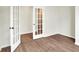 Bright bedroom featuring wood flooring, white trim, and elegant doors, creating a stylish and inviting space at 1603 Clover Crossing Dr # 1A, Greenfield, IN 46140
