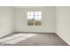 This bedroom has neutral carpeting, a large window for lots of light and fresh neutral paint at 1603 Clover Crossing Dr # 1A, Greenfield, IN 46140