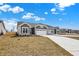 Charming single-story house showcasing a grey exterior, a two-car garage, and a paved driveway at 1603 Clover Crossing Dr # 1A, Greenfield, IN 46140