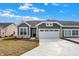 Inviting home with a two-car garage and stone accents on a partially-landscaped lawn at 1603 Clover Crossing Dr # 1A, Greenfield, IN 46140