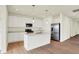 Modern kitchen with white cabinets, stainless steel appliances, and a center island with sink at 1603 Clover Crossing Dr # 1A, Greenfield, IN 46140