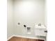 Practical laundry room with essential hookups, featuring durable flooring and a utility sink for added functionality at 1603 Clover Crossing Dr # 1A, Greenfield, IN 46140