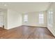 Bright living room with hardwood floors and large windows, perfect for relaxing or entertaining at 1603 Clover Crossing Dr # 1A, Greenfield, IN 46140