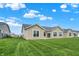 Expansive backyard view showing well-maintained lawns and the home's rear exterior with ample windows at 1609 Clover Crossing Dr, Greenfield, IN 46140