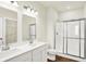 Bathroom featuring double sink vanity, walk-in shower with glass door, and chrome fixtures at 1609 Clover Crossing Dr, Greenfield, IN 46140