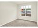 Bright bedroom features neutral carpet, pale walls, and a large window at 1609 Clover Crossing Dr, Greenfield, IN 46140