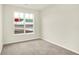 Bright bedroom features neutral carpet, pale walls, and a large window at 1609 Clover Crossing Dr, Greenfield, IN 46140