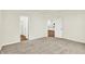 Bright bedroom features neutral carpet, pale walls, and doorways to the bathroom and kitchen at 1609 Clover Crossing Dr, Greenfield, IN 46140