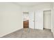Bright bedroom features neutral carpet, pale walls, and doorways to the kitchen and closet at 1609 Clover Crossing Dr, Greenfield, IN 46140