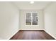 Cozy bedroom featuring a large window, neutral paint, and wood-look flooring at 1609 Clover Crossing Dr, Greenfield, IN 46140