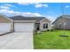 Attractive single-story home featuring a two-car garage, stone accents, and a meticulously maintained lawn at 1609 Clover Crossing Dr, Greenfield, IN 46140