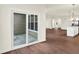Bright living room with sliding glass door, seamless indoor-outdoor living, and modern hardwood flooring at 1609 Clover Crossing Dr, Greenfield, IN 46140