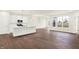 Open living space filled with natural light, showcasing white cabinets and an island with an eat-in breakfast bar at 1609 Clover Crossing Dr, Greenfield, IN 46140