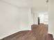Open living space with wood floors and a view into the kitchen at 1609 Clover Crossing Dr, Greenfield, IN 46140