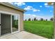 Sliding glass door leading to a concrete patio with an open lawn and views of the trees at 1609 Clover Crossing Dr, Greenfield, IN 46140
