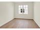 Cozy bedroom with a large window offering natural light and view to the outside at 1615 Clover Crossing Dr # 2A, Greenfield, IN 46140