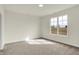 Bright bedroom features carpet and a large window for ample natural light at 1615 Clover Crossing Dr # 2A, Greenfield, IN 46140